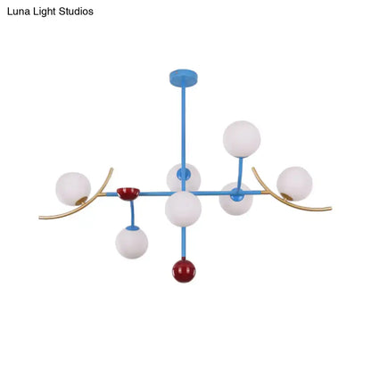 Modern blue and gold lamp fixture with opal glass ball shades and red accents for dining room glass ball island lighting