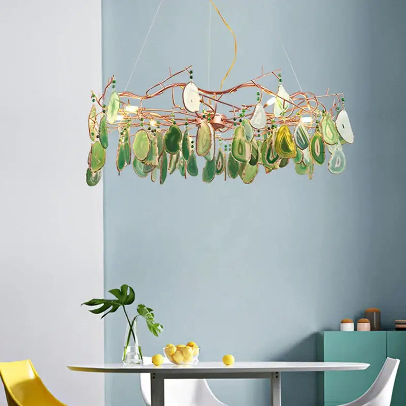 A modern copper-toned decorbites agate chandelier with green and white agate slices for colorful led lighting in dining rooms