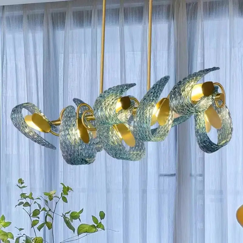 Modern blue and green decorbites glass chandelier with swirling translucent shades and gold-toned metal fixtures for dining room light