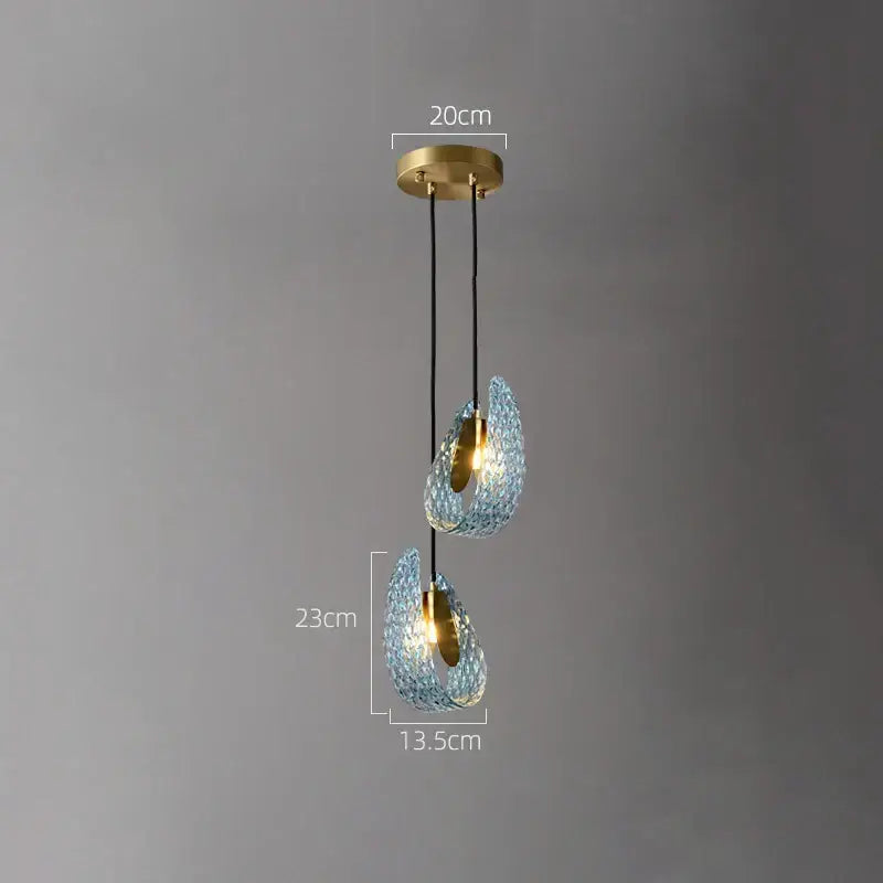Modern blue and green decorbites glass chandelier featuring textured blue glass with gold-toned metal accents for dining rooms