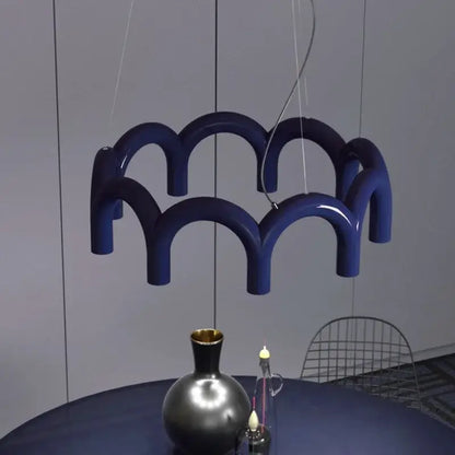 Modern blue metal arch chandelier featuring a deep blue glossy ceramic pendant light with a wave-like design