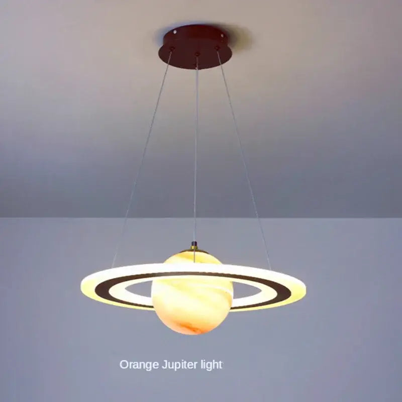 Modern blue planet pendant light with rings featuring a warm orange decorbites acrylic planet orb for bedroom decor