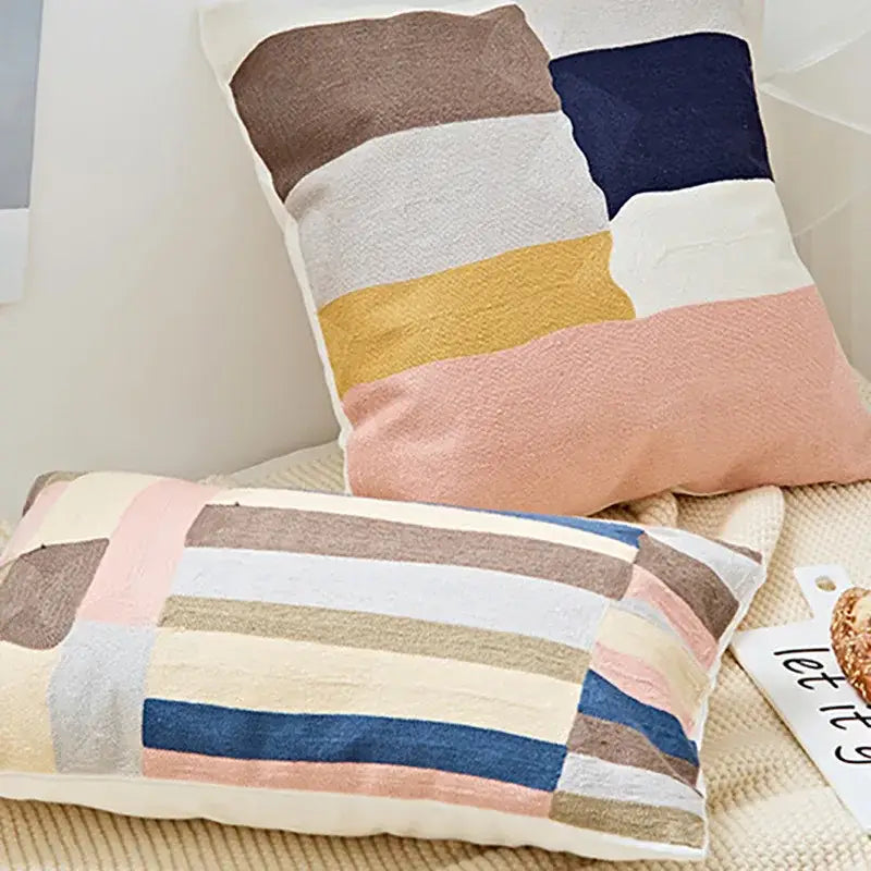 Rectangular embroidered geometric cotton cushion cover with patchwork stripes in muted brown navy beige yellow and pink