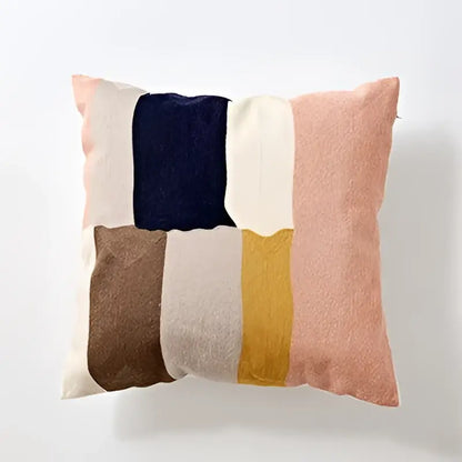 Soft modern patchwork cushion cover with muted pink, navy, cream, mustard, and brown embroidered geometric cotton design