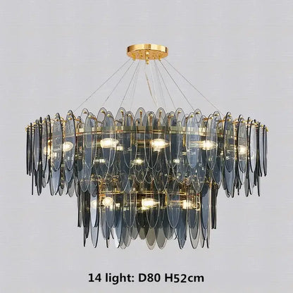 A modern pendant light with cascading blue glass discs and gold metal chain decorbites gold metal framing