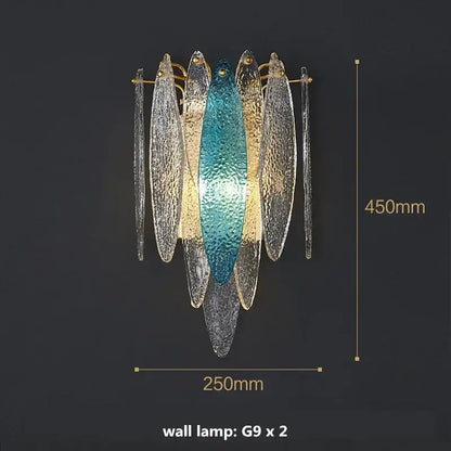 A modern wall lamp with teal and gold glass fish paired with modern blue and white leaf pendant lights with gold metal chain decorbites gold metal