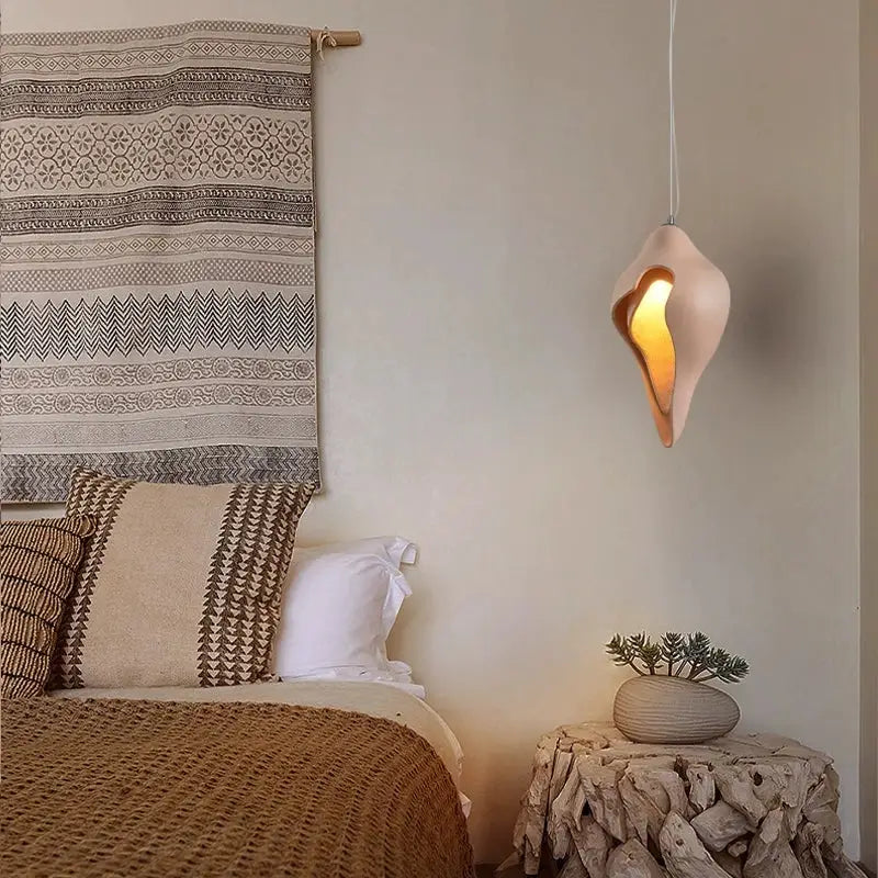 Modern blush pink ceramic pendant light with warm glow shaped like a shell for dining room decorbites conch chandelier