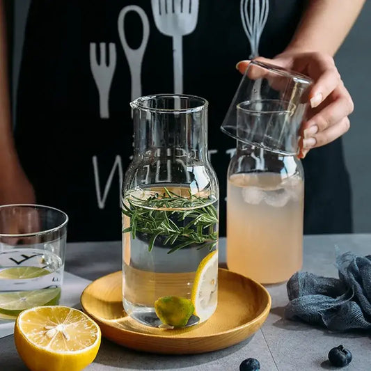 Clear glass borosilicate carafe filled with water lemon and rosemary from modern glass drinkware set for kitchen use