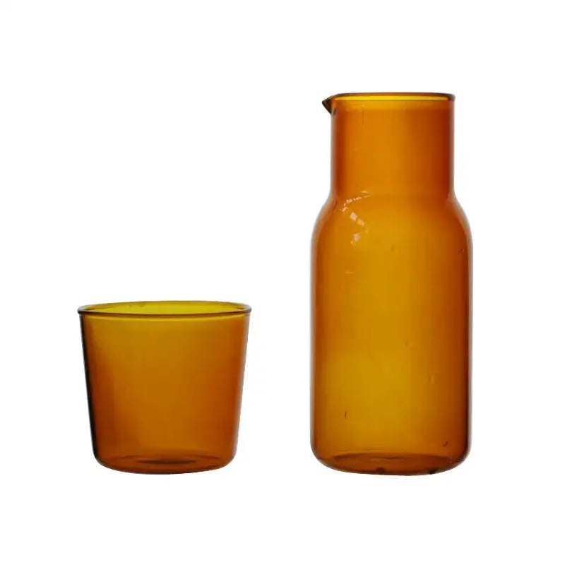 Amber-colored modern borosilicate glass tea pot with narrow spout and rounded body for kitchen fruit infuser use