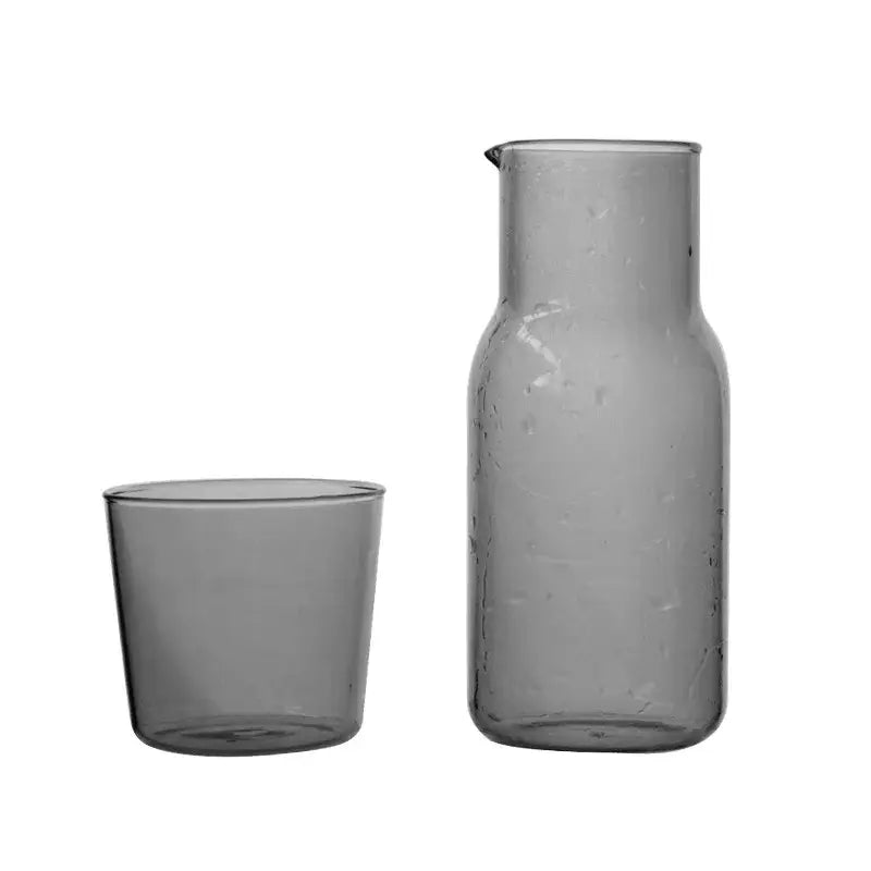 Matte gray glass tea pot with slender neck and subtle texture paired with matching tumbler for modern kitchen use