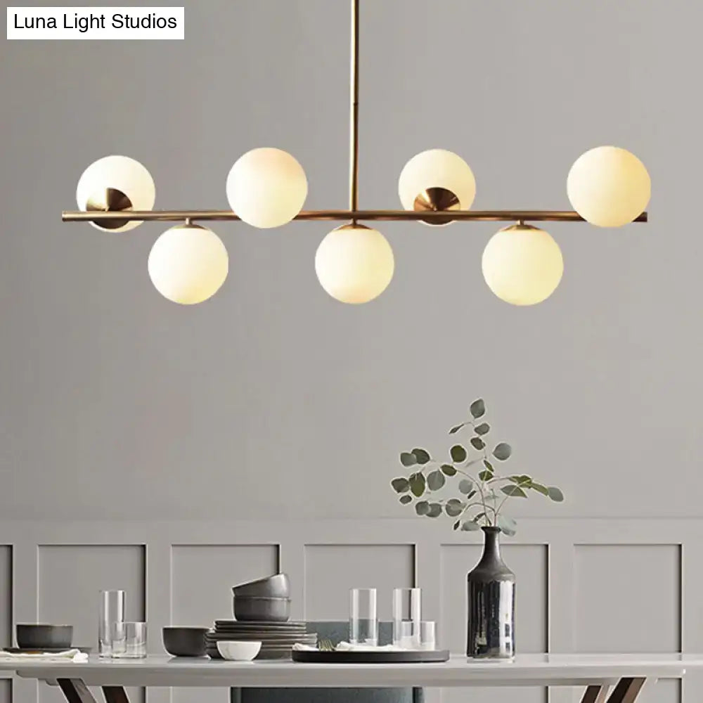 Decorbites sleek cream glass spherical dining room pendant light with brass finish and six frosted globe shades
