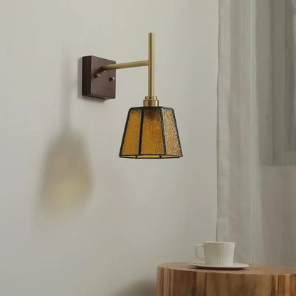 Modern brass wall lights featuring a textured amber glass copper led shade for bedroom sconce lighting