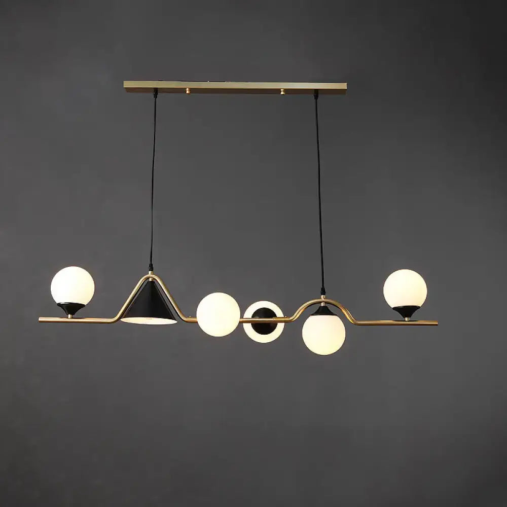 Modern brass and black geometric ball hanging island light with frosted glass globe bulbs for dining room by DecorBites