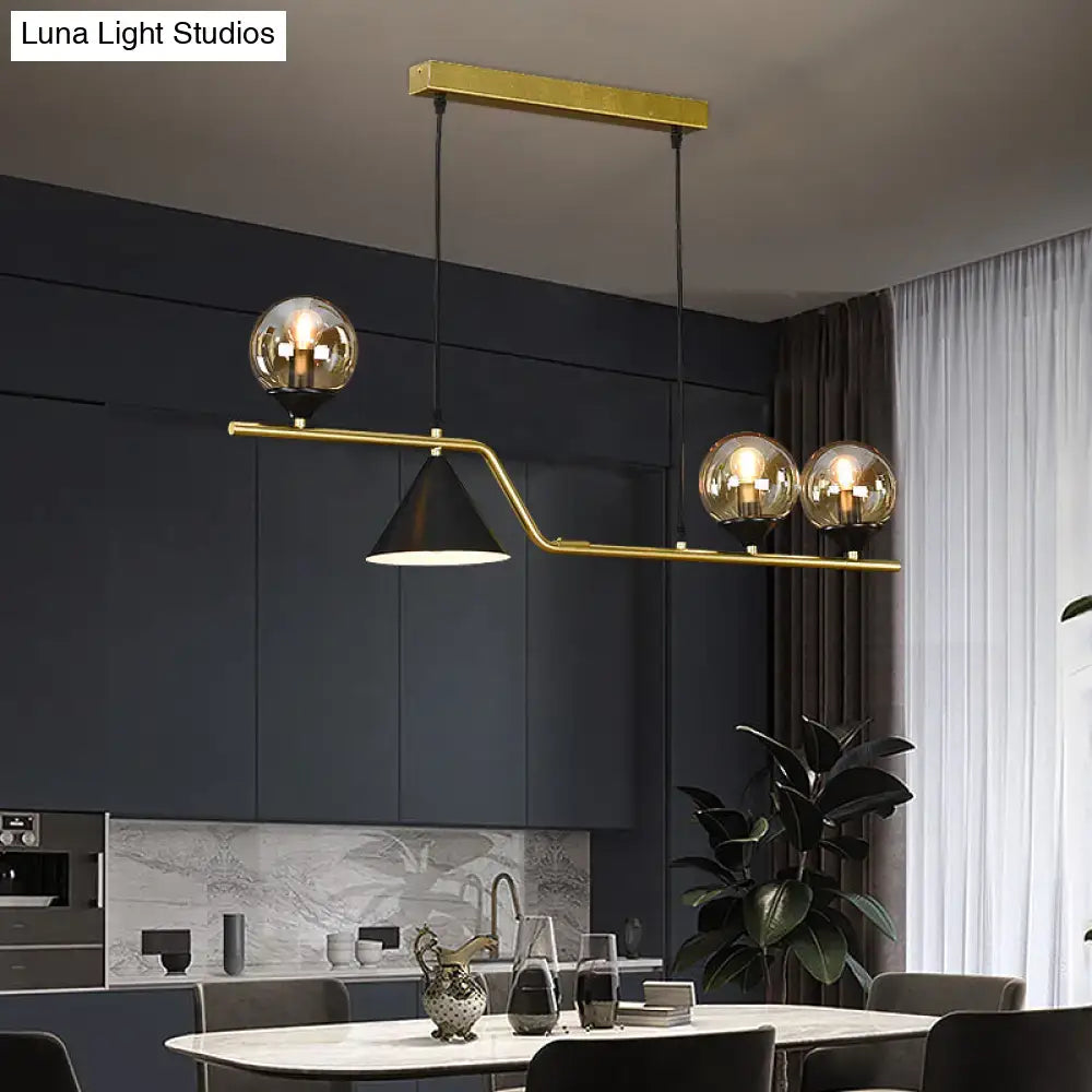 Modern gold metal dining pendant lamp featuring three glass ball hanging bulbs and a black conical hanging island light shade