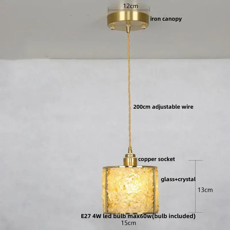 Modern brass and blue glass crystal led pendant light with textured shade suspended by copper wire from brass canopy