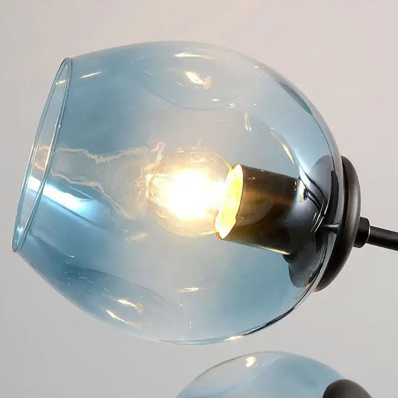 Modern brass and blue glass iron ball chandelier with a translucent blue glass globe lampshade for dining room