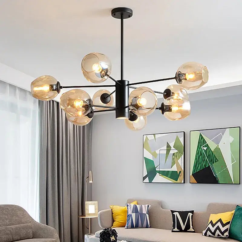 Gold-toned modern iron ball chandeliers with clear glass globes for dining room featuring brass and blue glass design