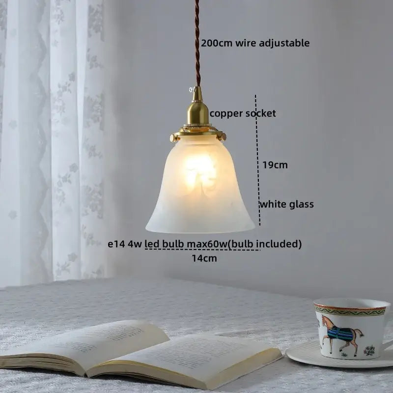 Modern brass and clear glass chandelier pendant light with a warm bell-shaped frosted glass shade for dining room