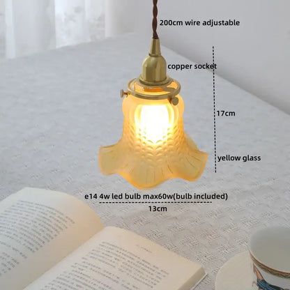 Modern brass and clear glass chandelier pendant light with warm yellow textured petal design for dining room