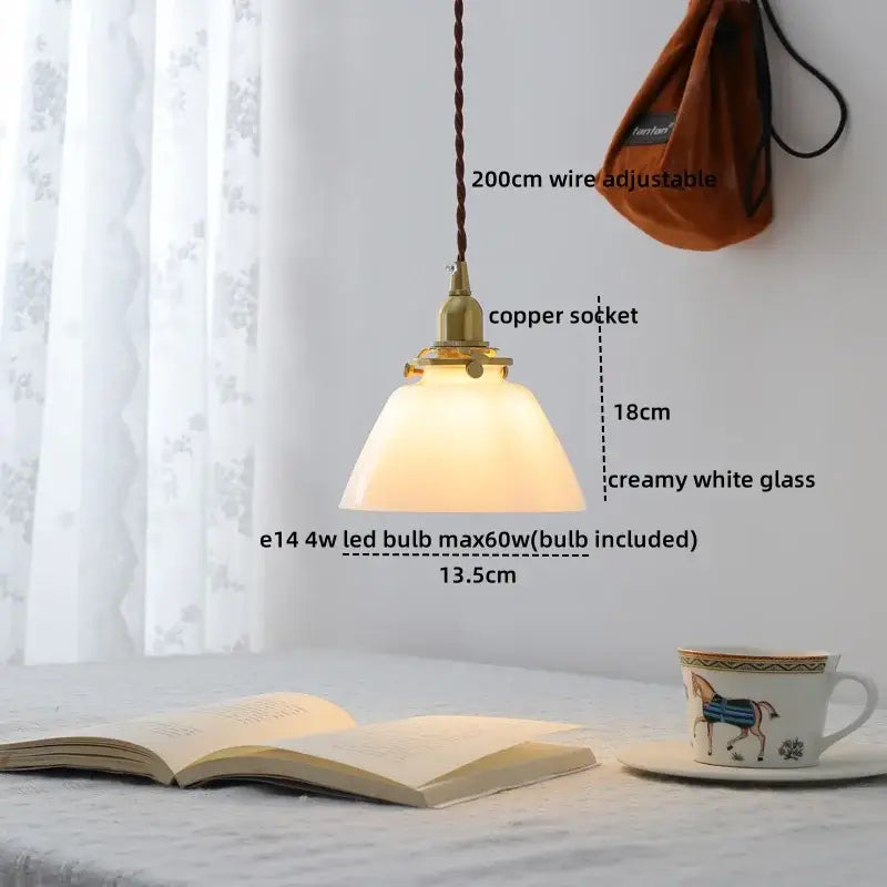 Modern brass and clear glass chandelier pendant light with creamy white shade and braided brown wire for dining room