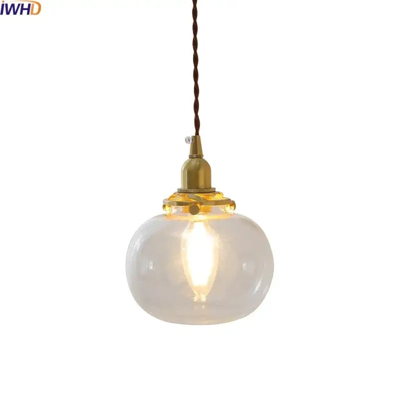 Modern brass and clear glass chandelier pendant light with warm-toned translucent shade and twisted brown cord for dining room