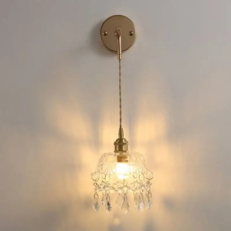 Modern brass wall lamp with clear glass chandelier shade and dangling teardrop crystals for bedroom decorbites clear glass