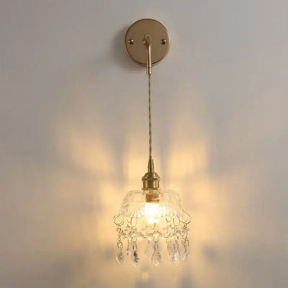 Modern brass wall lamp with clear glass chandelier shade and dangling teardrop crystals for bedroom decorbites clear glass