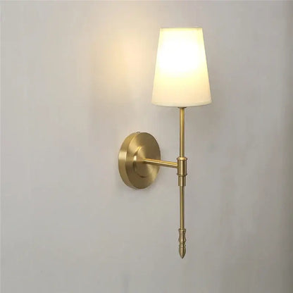 Modern brass and cream fabric led wall lamp with brass finish and cream shade ideal for bedroom wall lamps