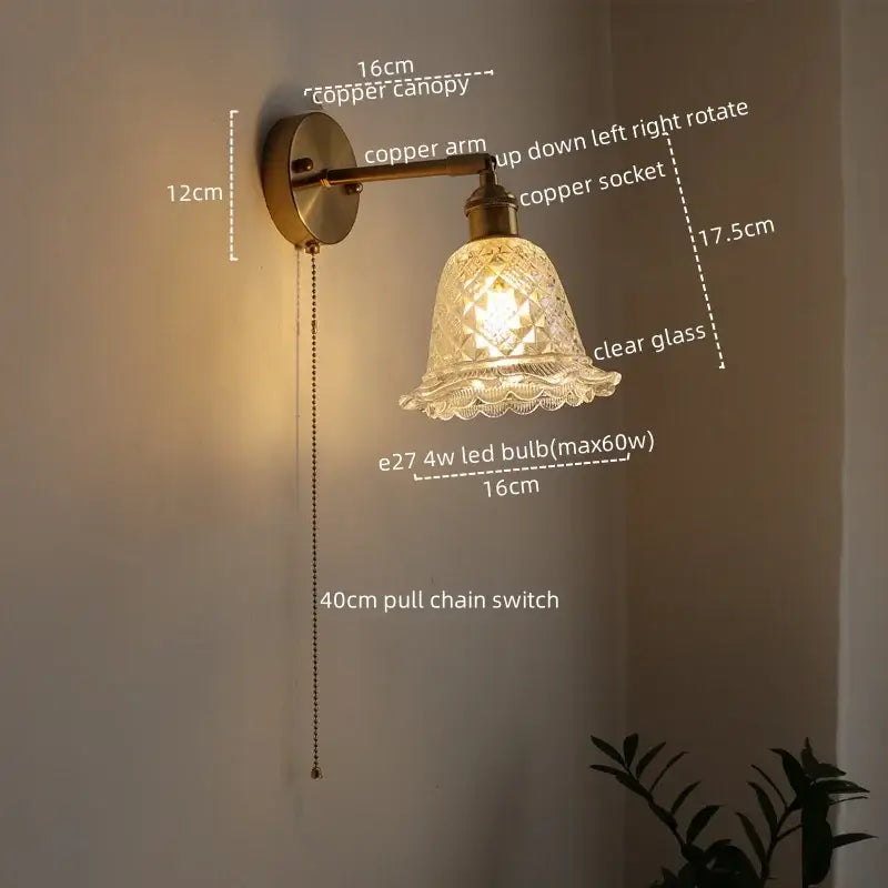 Modern brass and crystal led wall lamps featuring an antique brass finish with a clear glass shade and adjustable copper arm wall lamps