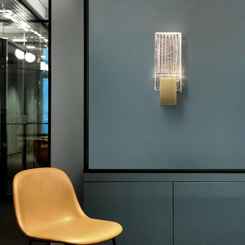 Modern brass and crystal wall light with a gold-toned base and textured glass panel for elegant decorbites crystal wall decor
