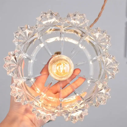 Clear intricately cut glass led pendant light with brass bulb holder designed for modern dining room lighting