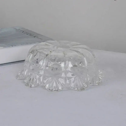 Clear glass bowl with faceted floral patterns and scalloped edge as part of a modern brass led pendant light