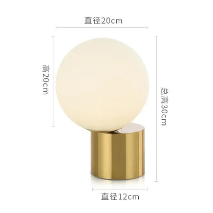Modern brass and decorbites glass circular table lamp with frosted white spherical glass globe and polished gold base