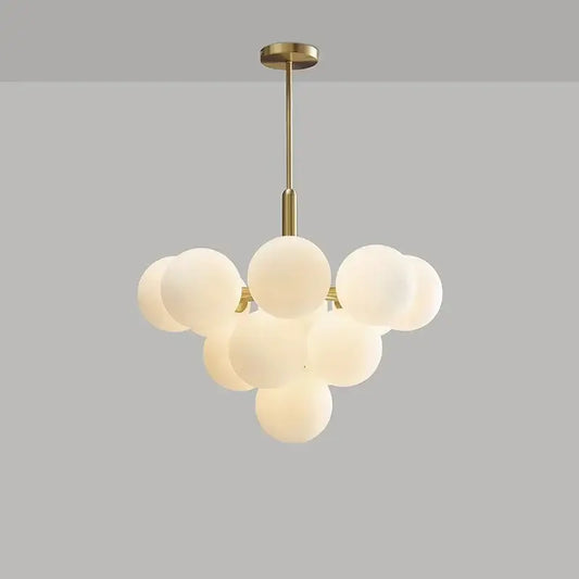 Modern brass and frosted glass chandelier with multiple glass spheres for living room dining decorbites elegant glass decor