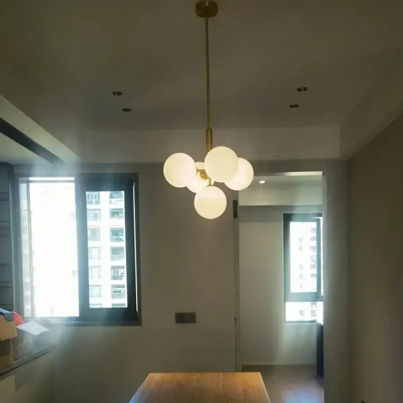 Modern brass and frosted glass chandelier with five globe bulbs for elegant glass chandelier living room decorbites decor