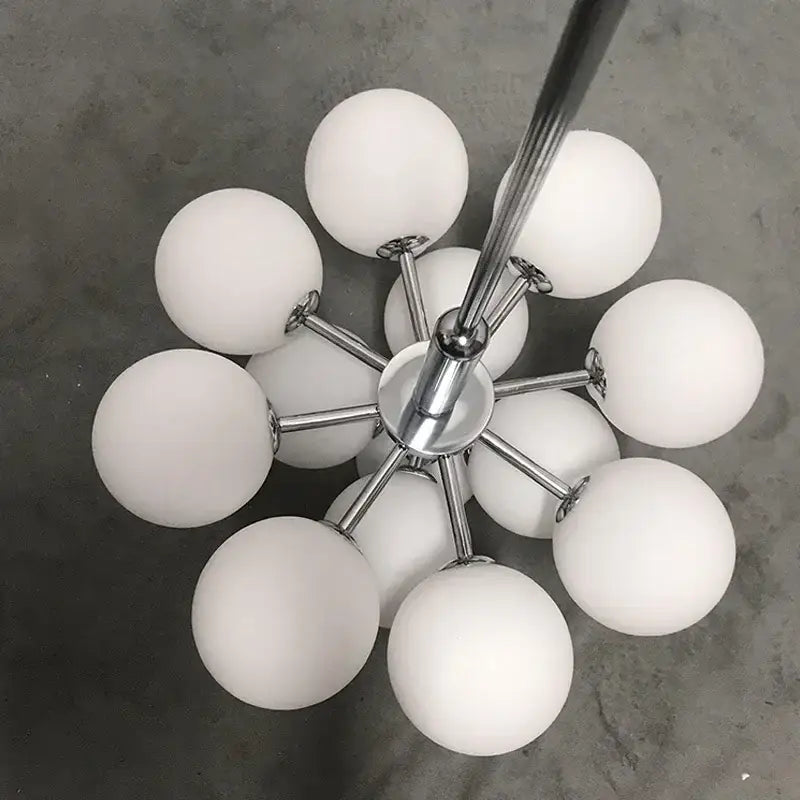 Modern brass and frosted glass chandelier with multiple white glass globes for elegant living room decorbites elegant glass chandelier