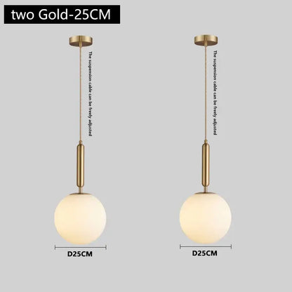 Modern brass and frosted glass pendant light with spherical globes and adjustable suspension cables for dining room chandelier pendant light