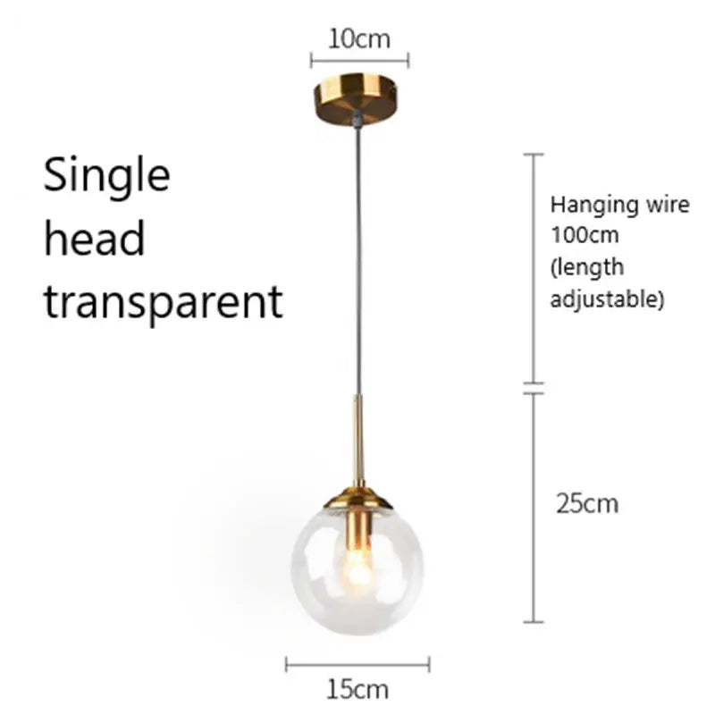 Modern brass and glass pendant light with transparent globe and adjustable gold-toned fixture for kitchen or dining room