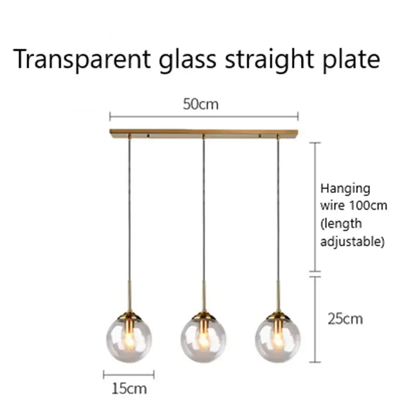 Modern brass and glass pendant lights with three clear glass pendant globes suspended from a wooden plate for kitchen dining room
