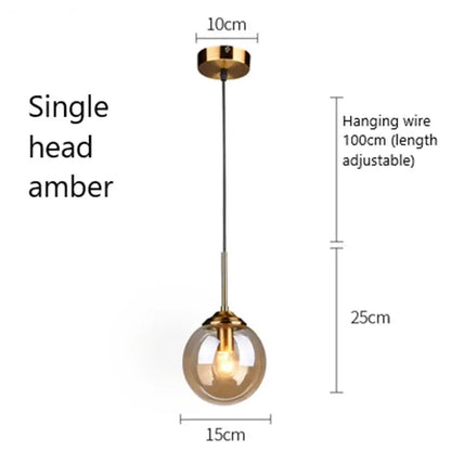A single amber glass pendant light with a gold-toned metal fixture modern brass pendant lights for kitchen
