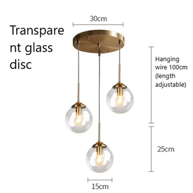 Modern brass and glass pendant lights featuring clear glass globe shades and brass accents for kitchen dining room