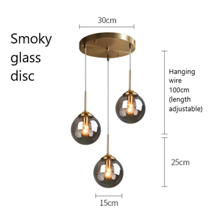Modern brass and glass pendant lights featuring three smoky glass pendant shades for kitchen and dining room use