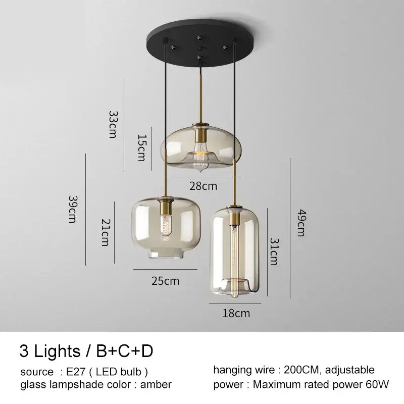 Modern brass and glass pendant lights with amber-tinted glass pendant shades for kitchen and dining room lighting