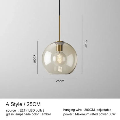 Modern brass and glass pendant lights featuring a spherical amber glass pendant lampshade for kitchen dining room use