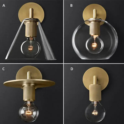 Modern brass and glass wall sconce with clear glass shades and exposed filament bulbs for bedroom lighting