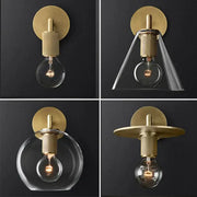 Modern brass and glass wall sconce featuring brass finish with clear glass shades and exposed bulb design for bedroom lighting
