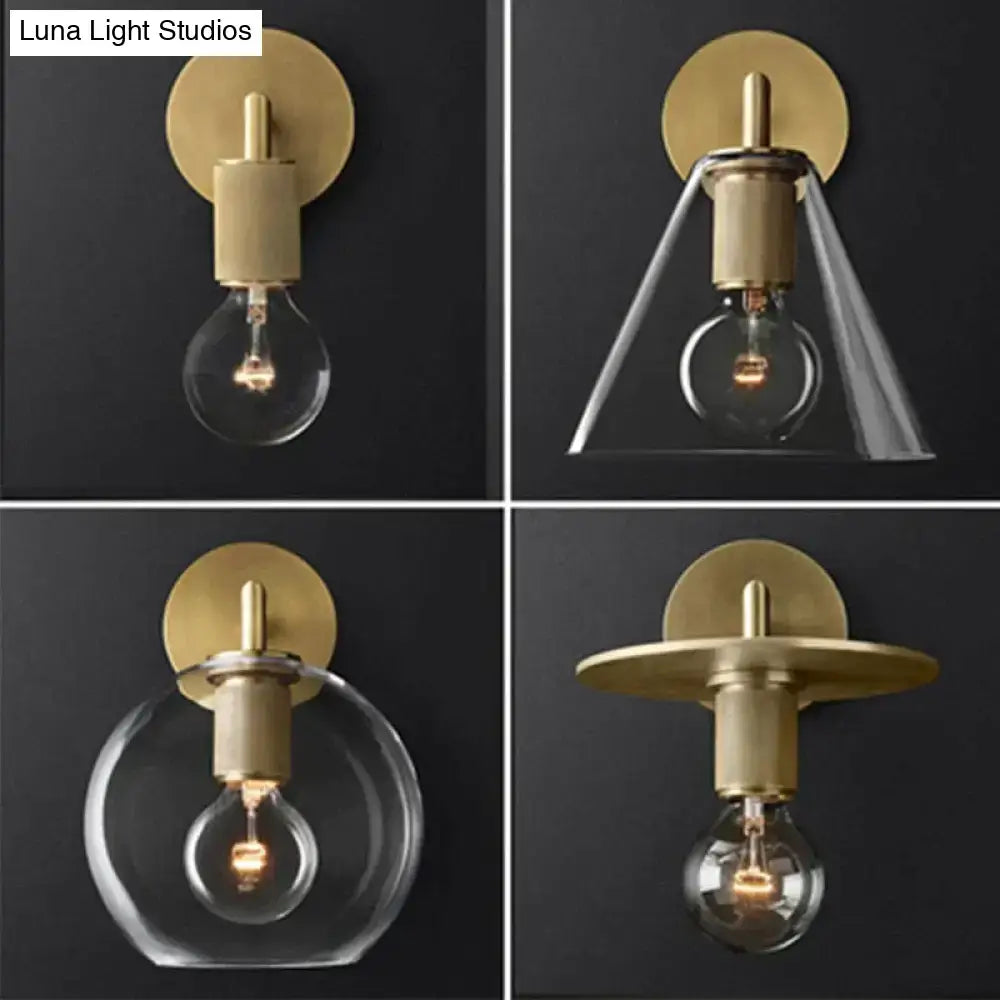 Modern brass and glass wall sconce with gold-toned finish clear glass shades and exposed filament bulbs for bedroom lighting