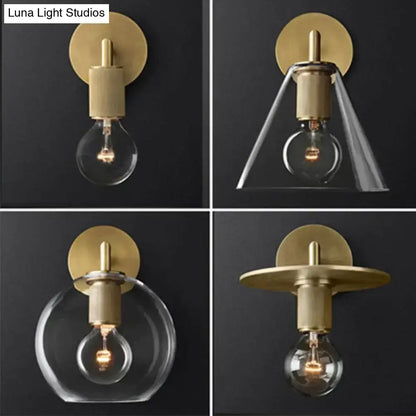 Modern brass and glass wall sconce with gold-toned finish clear glass shades and exposed filament bulbs for bedroom lighting