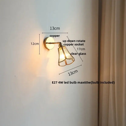 Copper-finished modern brass and gray glass led wall sconce with clear glass shade and adjustable up-down rotation