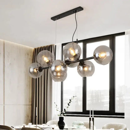 Modern black metal chandelier with smoked glass globe bulbs designed as gray glass pendant lights for kitchen dining room